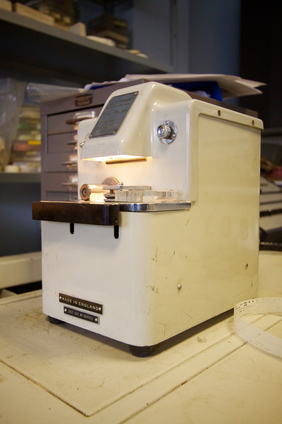 Figure 2 — An Elliott paper-tape reader with its lit reading slot — it reads the holes (here optically) and serializes them onto the line at full speed, faster and cleaner than live typing. (Marcin Wichary, W…