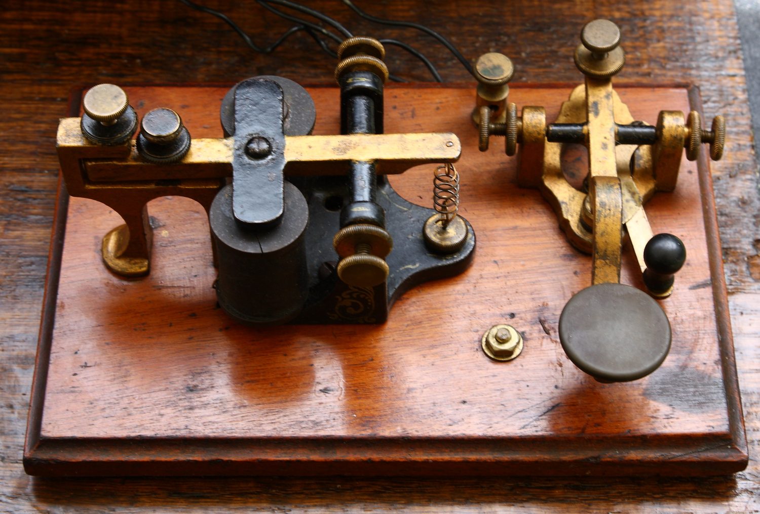 Figure 3 — A KOB — Key On Base — set: a telegraph key (right) and a sounder (left) mounted together on one wooden base, the compact everyday instrument of the small office and the learner's table. This is the…
