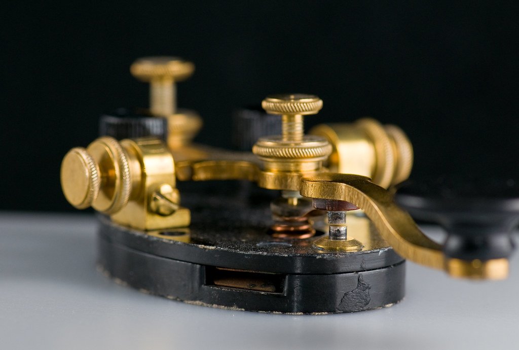 Figure 2 — The working parts in the metal — a brass key's knurled gap and tension screws, coil spring, contacts, and trunnion bearings. Compare the schematic in Volume 1. (photobunny, Flickr, CC BY-NC-ND 2.0.)